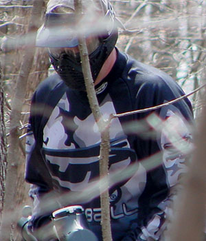 Scott Goeres walking through timber toward the camera
